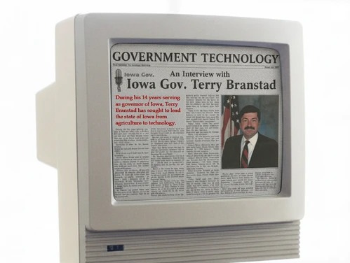 old 1990s computer monitor displaying a news article about Gov. Terry Branstad creating the Iowa Communications Network