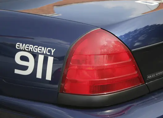 "Emergency 911" written on the back of an emergency vehicle