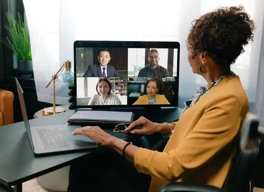 Women looking a computer screen with a Zoom video conferencing session.