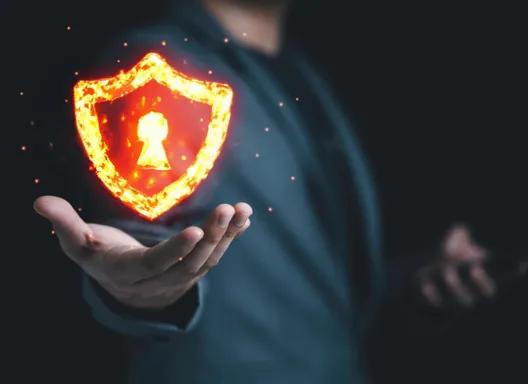 a floating shield and padlock icon that is made of fire