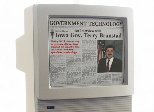 old 1990s computer monitor displaying a news article about Gov. Terry Branstad creating the Iowa Communications Network