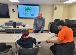 Man showing fiber to two students