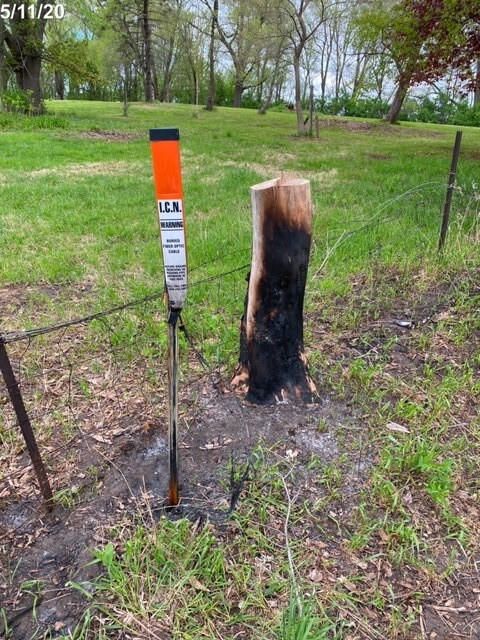 A ditch burning caused a large blackened area around our site/fiber sign. The burning took out the nearby tree.