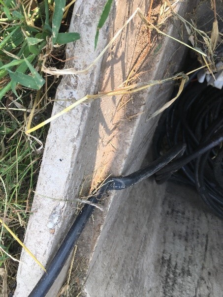 Our OSP team found that someone set the handhold lid on top of the fiber instead of using the duct that was there previously.