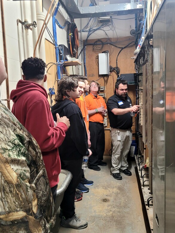 Students viewing a telecom closet.
