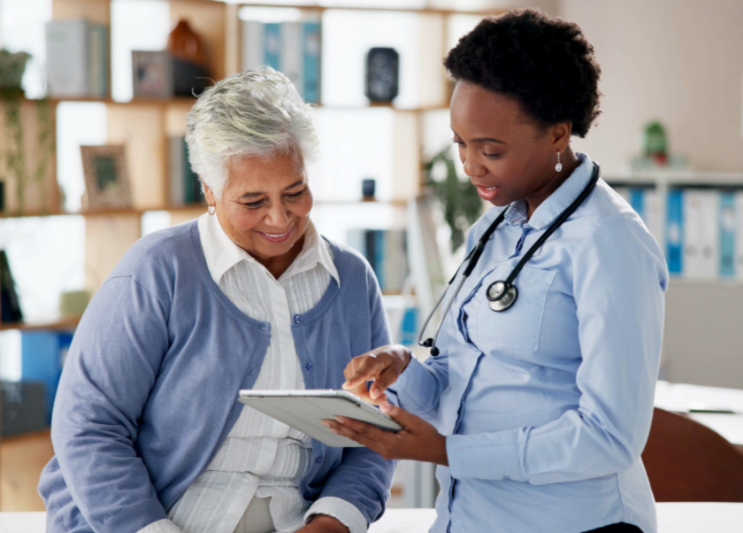 heathcare setting, two people looking at tablet