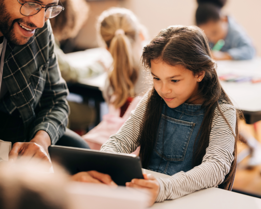 Student and teacher looking at tablet